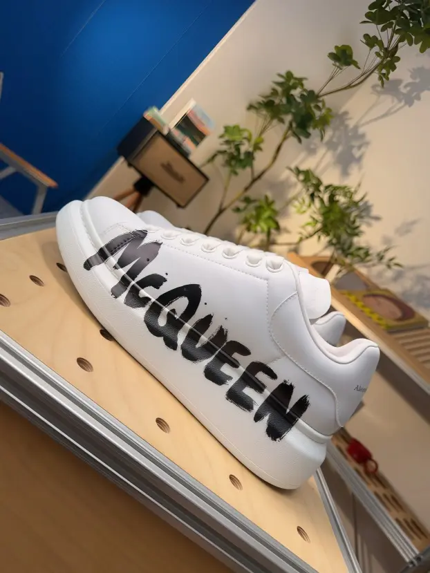 Breathable athletic shoes with white leather and black graffiti letter, lightweight for walking and daily outing.