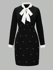 A long-sleeved Fitted dress with a black and white contrasting bow tie for ladies, exuding elegant charm and suitable for all occasions.