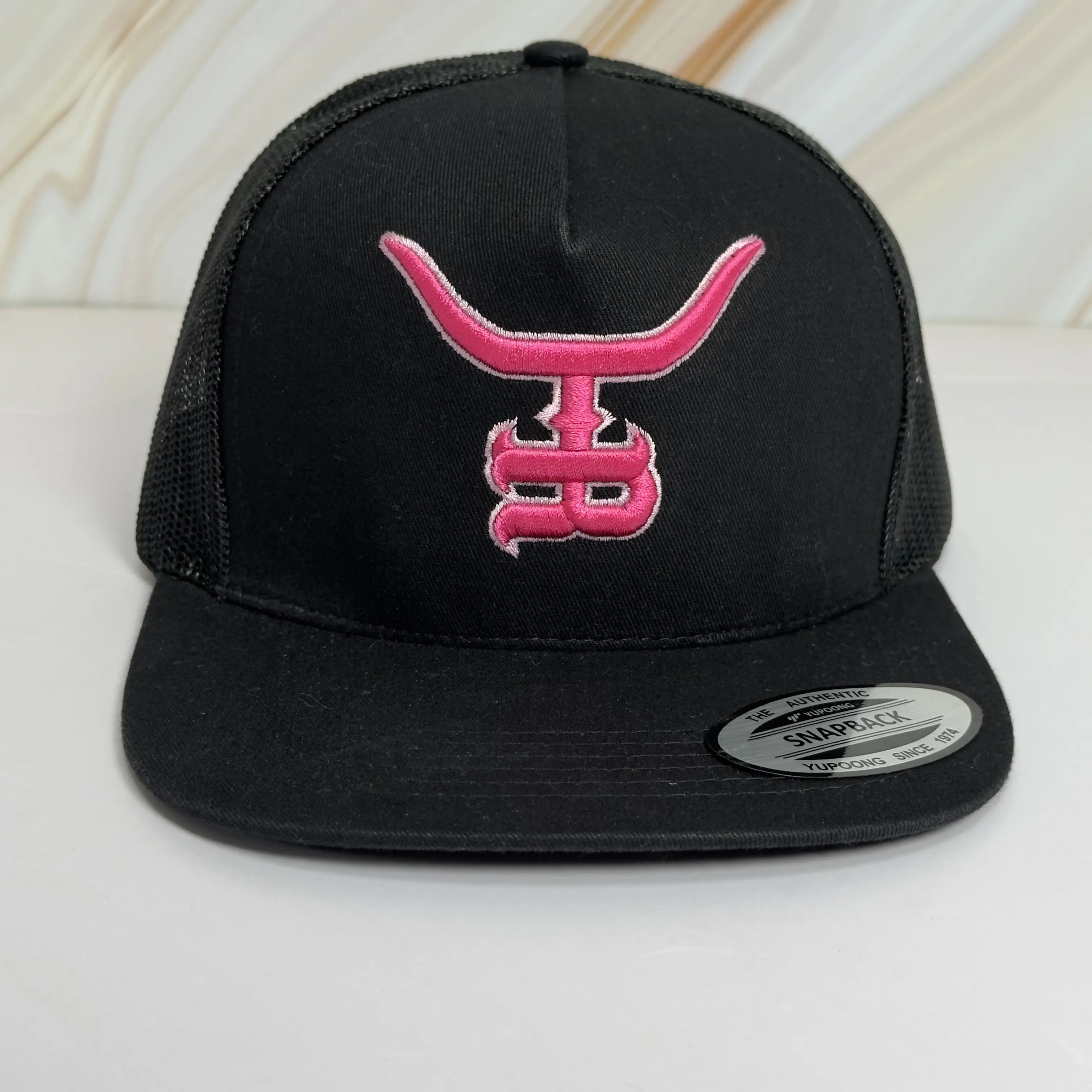HOTSHOT flat bill trucker SnapBack with hot PINK 3D embroidered logo and hot pink stitching on the side!