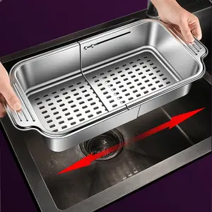 A stainless steel colander, placed on the sink, can be adjusted in size. It is used for cleaning fruits and vegetables, draining pasta, and drying dishes. It is a must-have tool for a home kitchen.