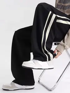 Men’s joggers with side double white stripes and contrasting colors, straight wide-leg cut; relaxed drape, high-street casual long pants. Comfortable and breathable for spring/autumn; versatile pants suitable for teens and plus sizes. Ideal for everyday c