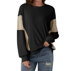 Women’s colorblock crewneck patchwork long-sleeve knit pullover sweatshirt in black with striped sleeves for cooler weather; comfortable fit and durable material; casual women’s wear; chic everyday gym wear; suitable for jeans.