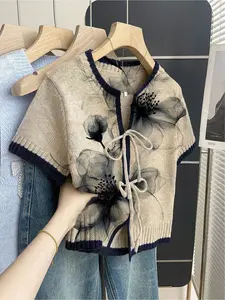 Women's khaki bohemian vacation short-sleeve knit top. Loose round neck, contrast black floral print, front tie and contrast piping. Perfect for spring & summer casual wear.