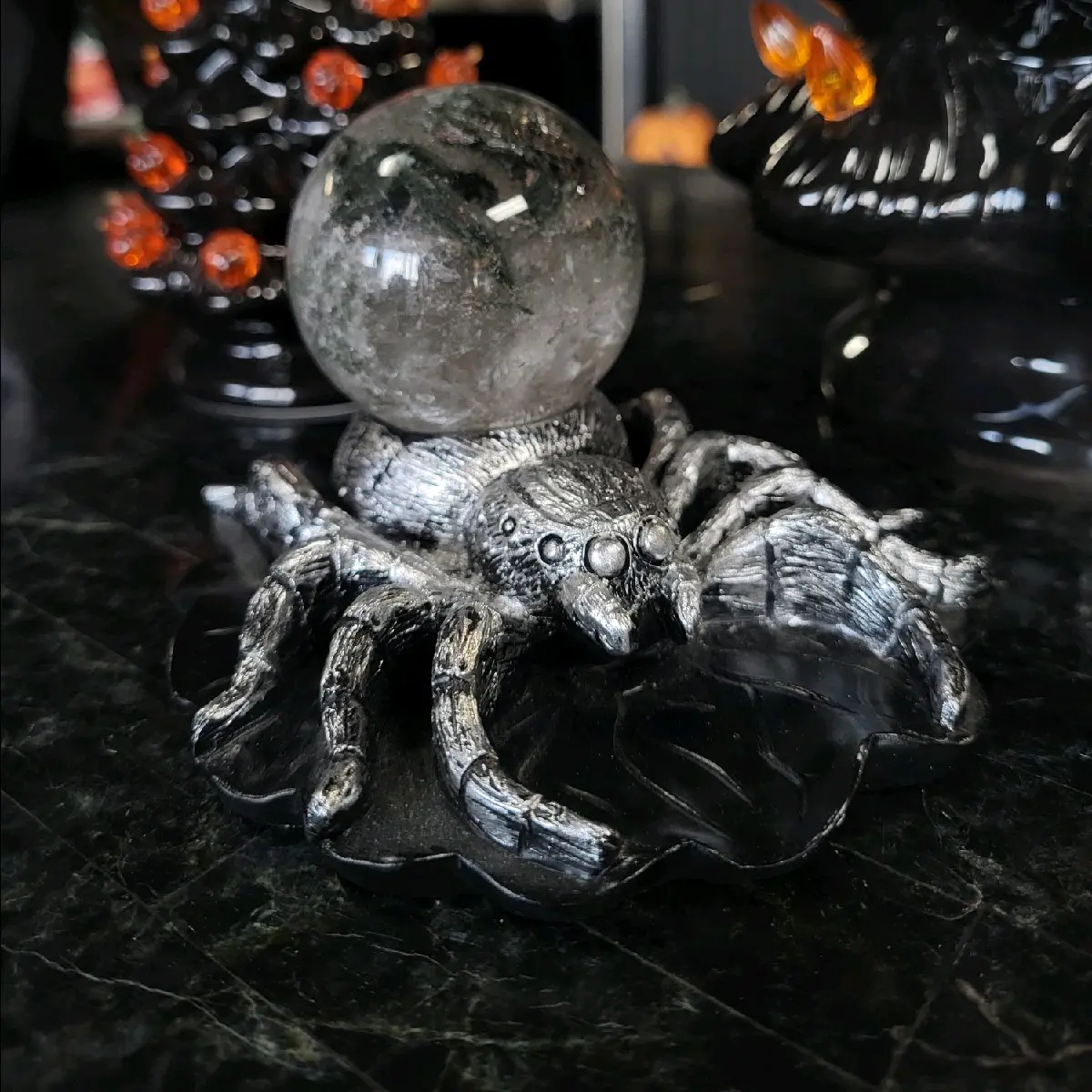 Moss agate crystal sphere with tarantula sphere holder