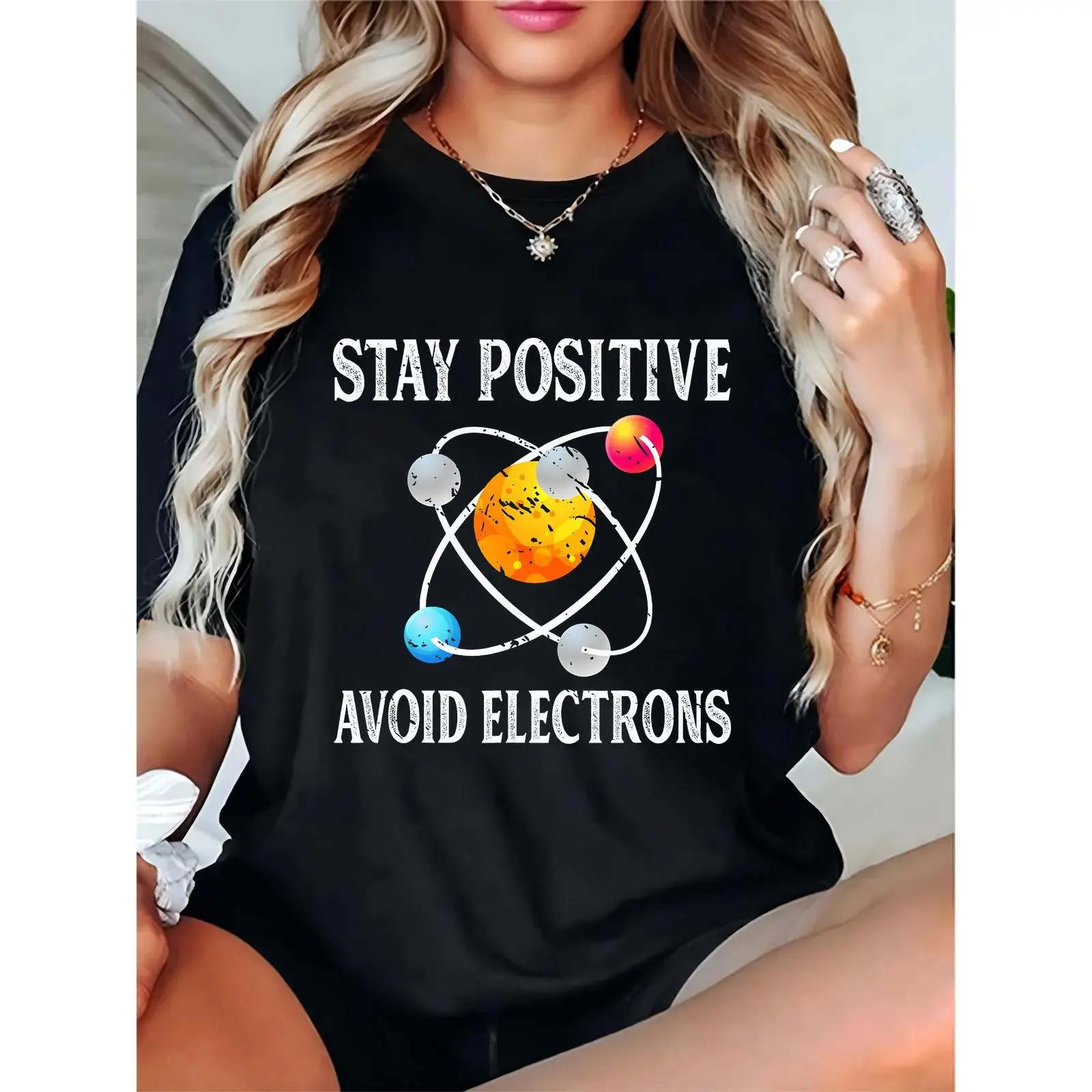Women’s Black T-Shirt with “Stay Positive Avoid Electrons” Colorful Atom Graphic | Casual Science-Themed Daily Top, Ideal for Science Enthusiasts