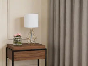 Modern table lamp with gold hollow metal base and white fabric shade. Geometric bedside nightstand lighting, compact and stylish. Suitable for bedrooms, living rooms and kids spaces.