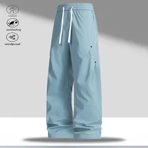 A pair of wide-leg casual pants, featuring a casual and simple style, with an adjustable drawstring at the waist for convenience. The wide-leg design is practical and versatile, while the side pockets and button details add a stylish touch. The fabric is