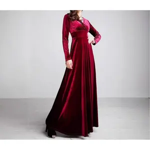 Women’s long velvet maxi dress with long sleeves and a V-neck, suitable for wearing over a raincoat