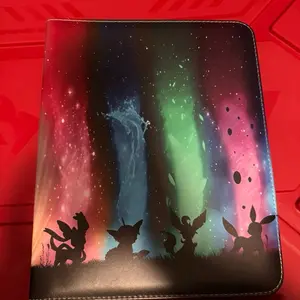EEVEE EVOLUTIONS CARD BINDER with Aurora Borealis Design and Silhouetted Characters for Collection