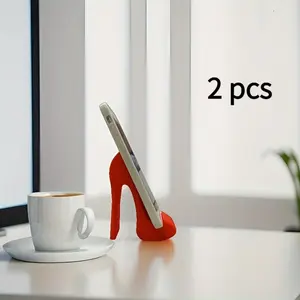 A creative set of two red high-heeled shoe phone stands, crafted using 3D printing technology. They make the perfect decorative accent for an office desk or bedside table—an ideal gift for Valentine's Day or Easter.