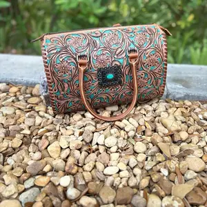 Large concho stone genuine hand tooled speedy bag with teal background . Crossbody strap included