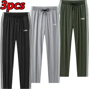 Men’s 3-pack casual lightweight quick-dry breathable sweatpants with side stripes, loose fit, “YOUNG” print, elastic waistband with drawstring, straight-leg joggers—suitable for everyday wear and sports.