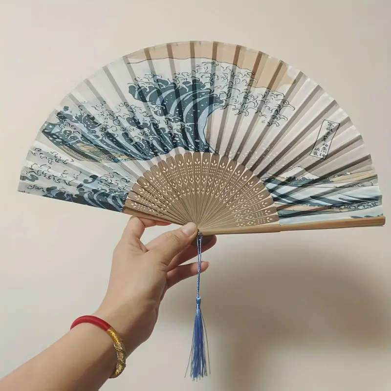This portable folding bamboo Hand Fan, inspired by Japanese retro design, is a perfect choice for women. Featuring the iconic Kanagawa Wave pattern, it serves as an elegant decorative piece, Decoration.