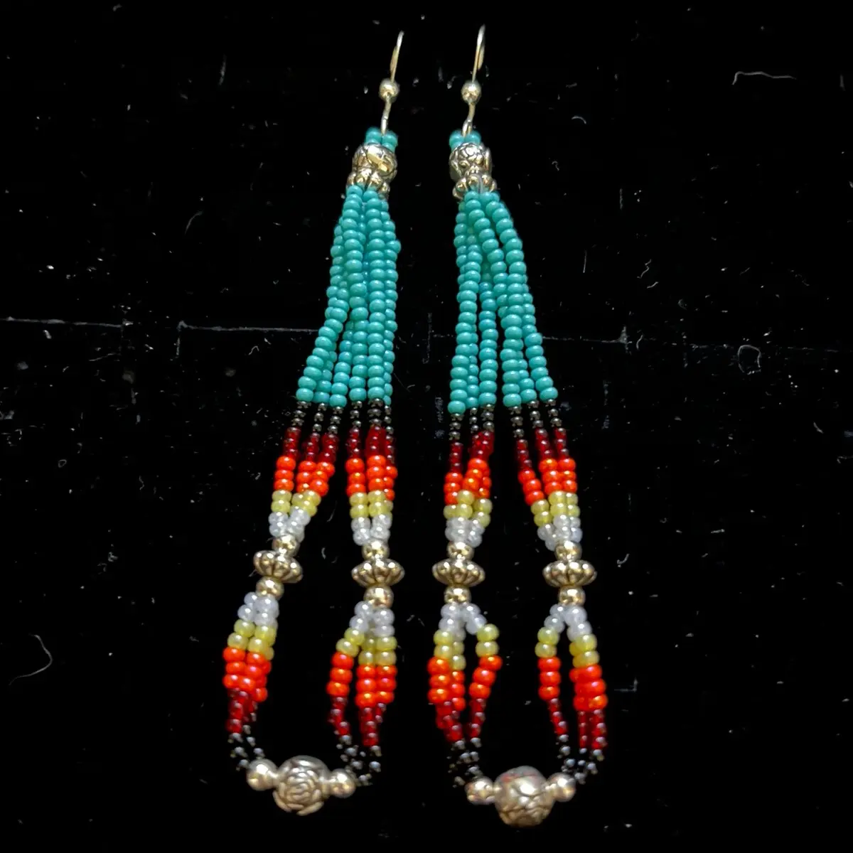 Navajo handmade beaded earrings adorned with sky blue turquoise seed beads with fire design seed beads, silver alloy daisy shape beads, and silver plated rose buds.