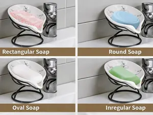 Leaf-shaped ceramic soap dish with self-draining design. Paired with a metal bracket, it keeps bars dry. Suitable for bathrooms, showers and kitchens. 2-piece set.
