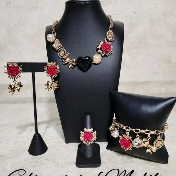 Gold Black Necklace Set with Red and Black Beads, Earrings, and Bracelet on Black Mannequin
