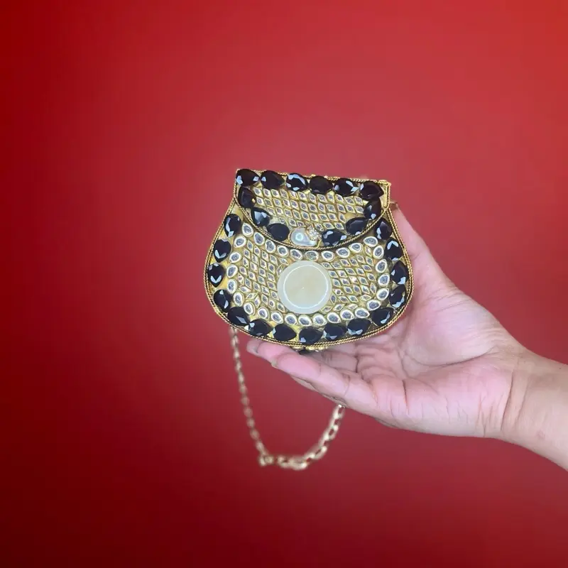 Black Kundan Clutch with Sparkling Stones and Pearl Accent for Elegant Occasions