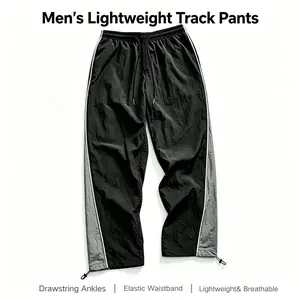 Men’s black-and-gray colorblock athletic pants, lightweight fabric, elastic drawstring waist plus adjustable cuffs, suitable for street style and everyday wear.