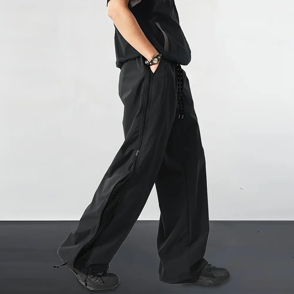 Men’s functional parachute pants with side zipper, high-street cutout mesh paneled wide-leg design, drawstring cuffs—sporty streetwear long pants