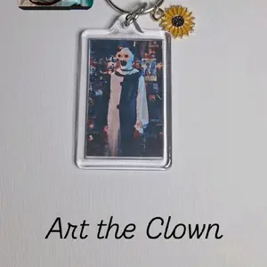 Art the Clown Keychains with Sunflower Charm and Transparent Frame Unique Collectible Accessory for Keys and Bags