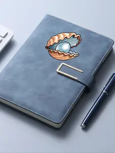notebook containing a pearl encased in a seashell, suitable for school and office use.