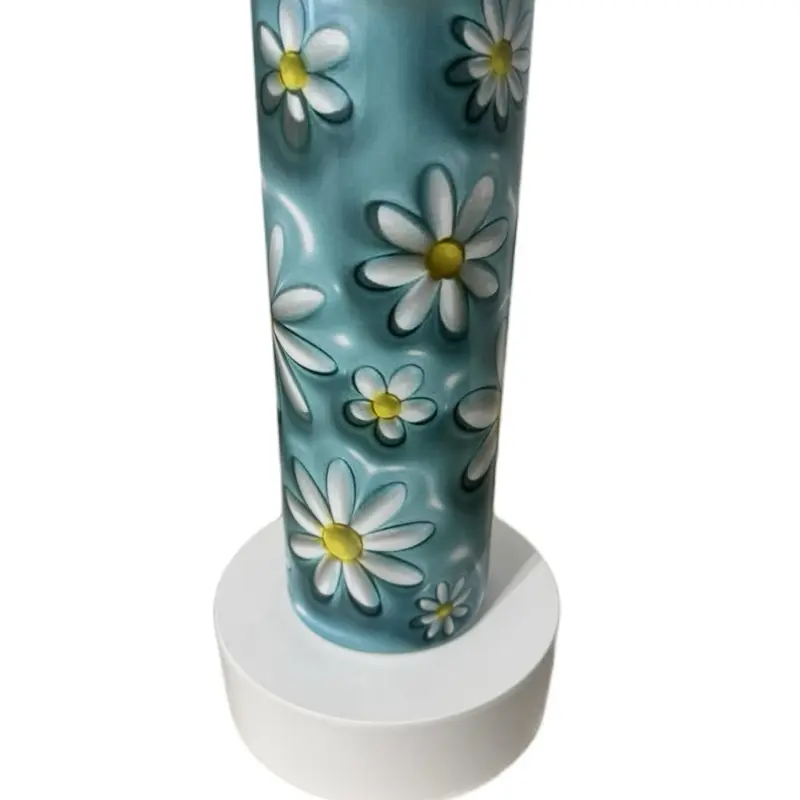 Daisy 20oz Tumbler with charming floral design on a light blue background