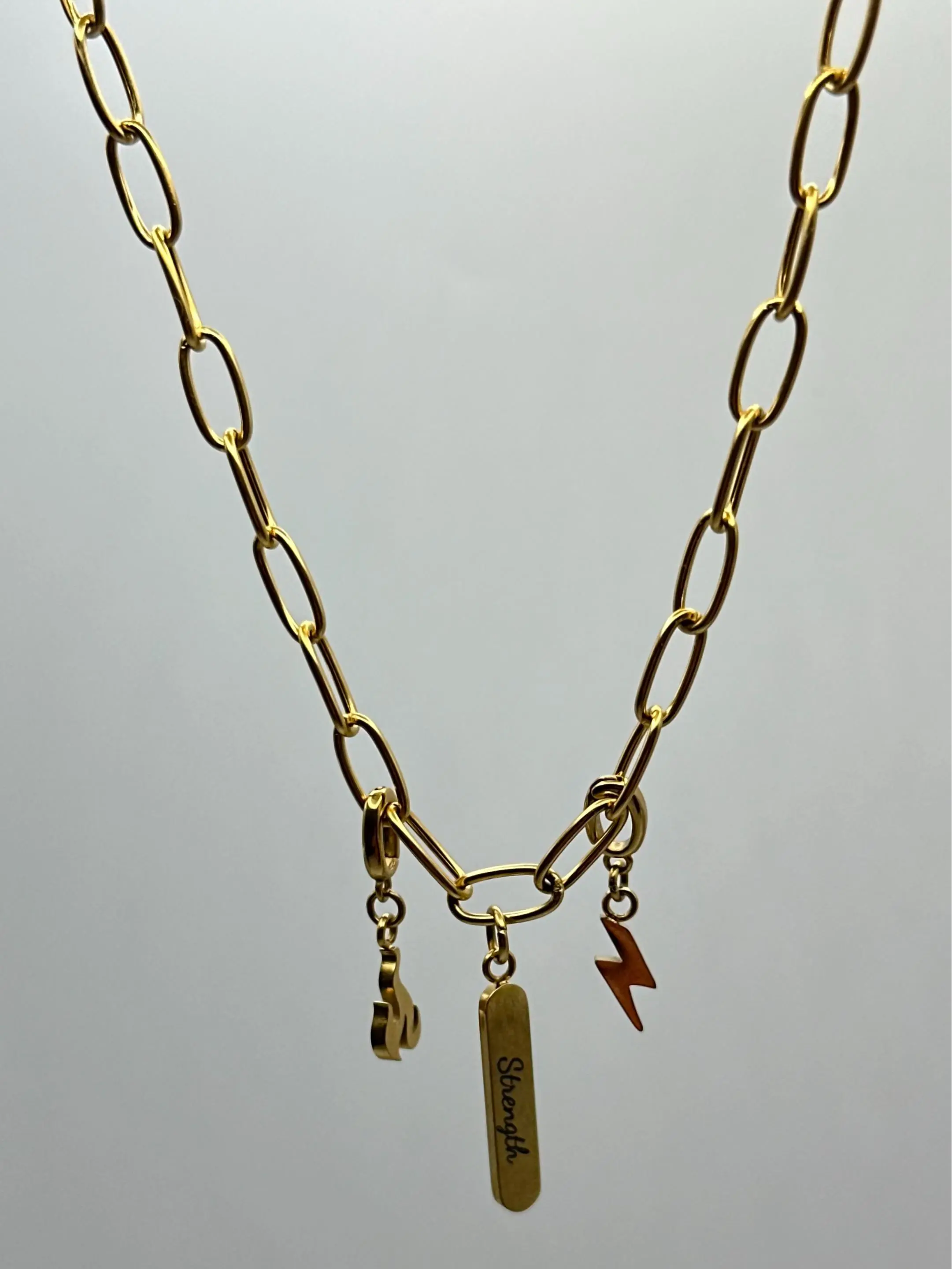 Pieces of Your Journey Strength Necklace, 18k PVD Gold Stainless Steel Unisex Necklace with Lightning Bolt, Fist Charms & Pre-Engraved "Strength" Bar, Waterproof, Hypoallergenic, Symbol of Resilience, Ideal for Everyday Wear