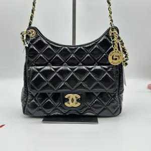 Pre-owned CHANEL hz8 Hobo Bag in black shiny crumpled calfskin with gold tone hardware. h22352