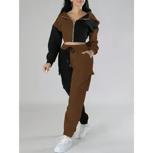 Sporty women's outfit: fashionable two-piece set with a short hooded jacket in contrasting colors and cargo sweatpants