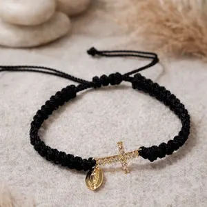 Adjustable Black braided protection bracelet featuring gold  cross and milagro charm