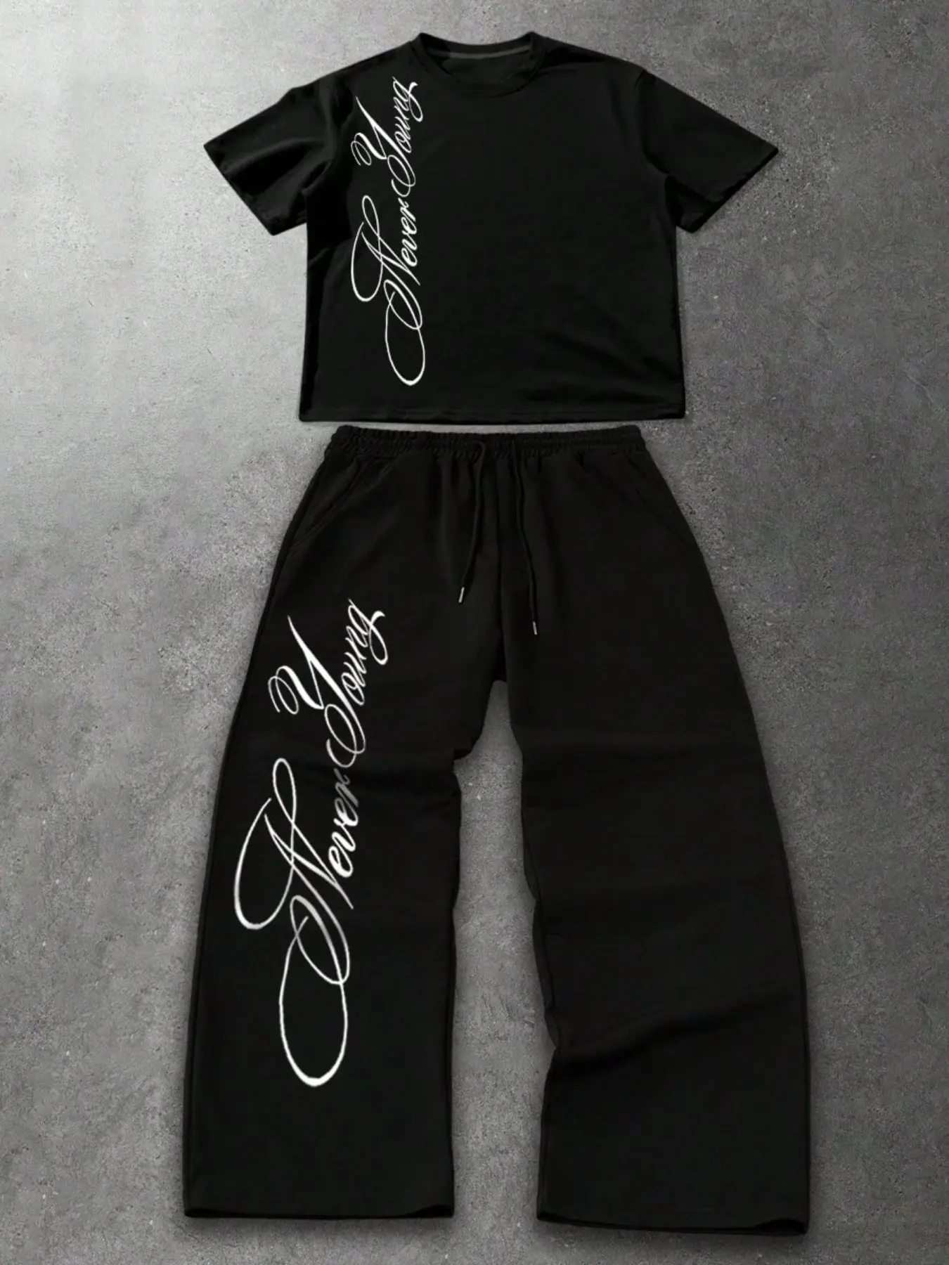 Comfortable Black Matching Two-Piece Set for Easy GRWM Outfits - 'Never Young' Script Printed Oversized T-Shirt and High-Waist Wide-Leg Joggers with Elastic Drawstring - Perfect for Airport, Lounge and Casual Hangouts.
