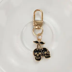 1/20pcs Gothic Cherry Skull Keychain – Golden-Tone Zinc Alloy Pendant with Black Enamel Skulls & Cherry Design, Edgy Men’s Car Key Accessory, Unique Backpack Charm, Creative Fashion Gift for Halloween or Birthdays, Bag Accessory