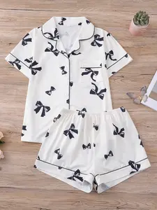 Butterfly themed two-piece women's sleepwear set, featuring a cute bow pattern all over the body, a short sleeved button up top, matching shorts, knitted fabric, collar and pocket details, suitable for women to wear throughout the four seasons