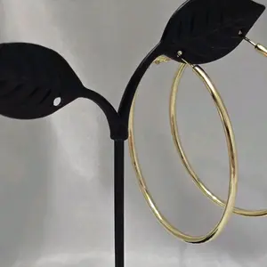 Large smooth gold hoop earrings. 45 mm diameter. High-quality laminated finish, water-resistant. Elegant everyday style.