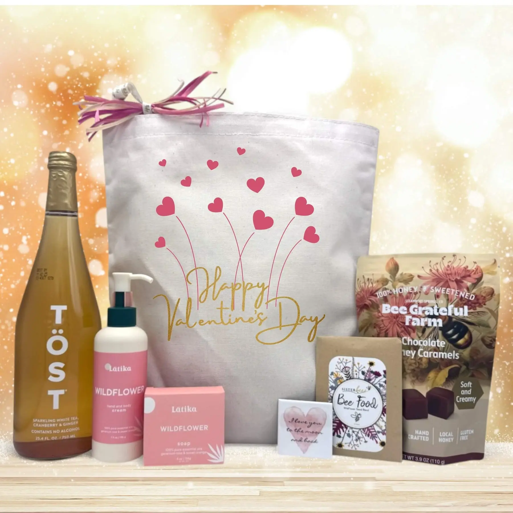 Itsonlynaturalgifts Festive Happy Valentine's Day Gift Basket with TÖST Sparkling Wine, Latika Wildflower Soap, and Bee Grateful Farm Chocolate Honey Caramels