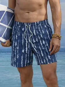 One blue-and-white tie-dye vertical stripe men’s beach shorts, urban casual style with a fresh, artistic blue-and-white tie-dye primary color. Elastic waistband with off-white drawstring for adjustable fit. Tie-dye vertical print adds trendy texture. Ligh