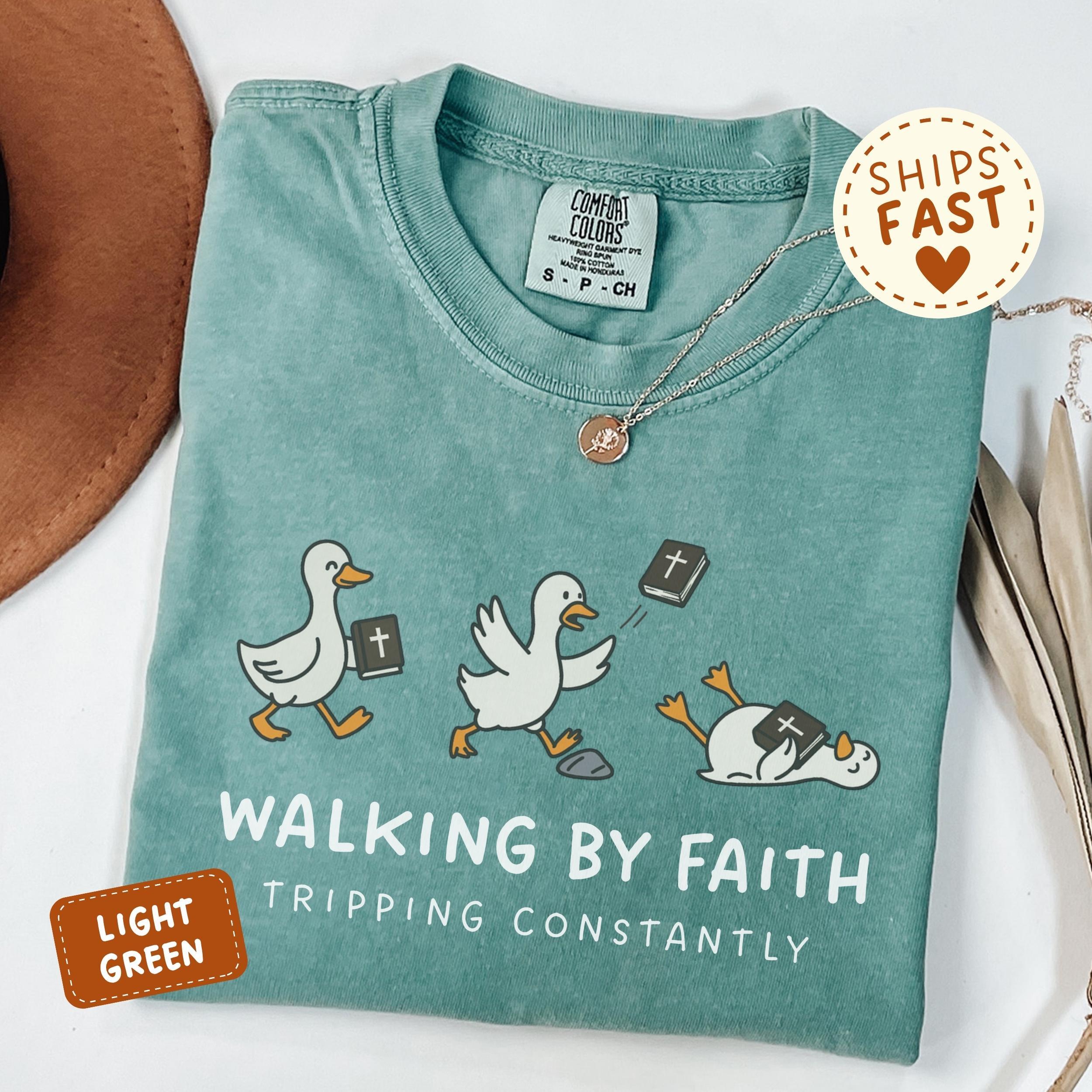 Women’s Comfort Colors Cotton Short-Sleeve Funny Graphic Christian Tee – Breathable Everyday Fit, “Walking By Faith Tripping Constantly” Goose Bible Verse Religious Humor Shirt, Gift For Friends (Thanksgiving, Easter, Valentine’s Day)