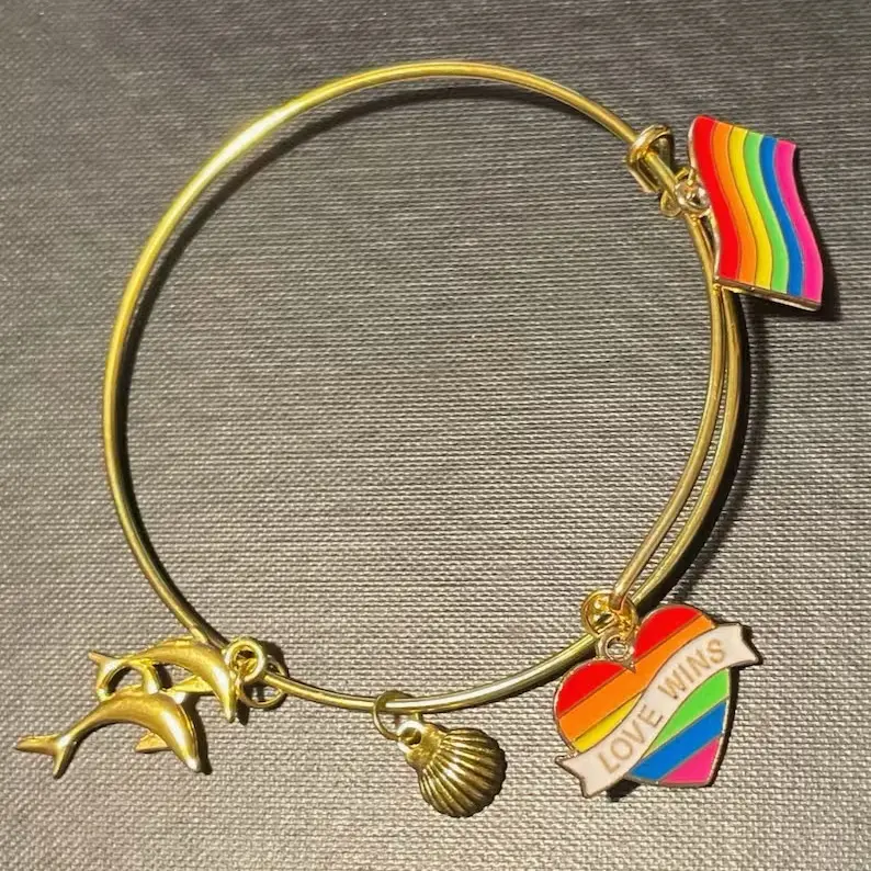 Pride X Sealife Gold Bangle with Rainbow Flag Heart Love Wins Charm and Dolphin Seashell Design