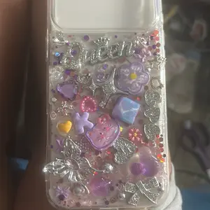 Glittery Phone Case with Heart and Flower Designs, Clear Background, Multiple Colors, Decorative Elements, Ideal for Personalization