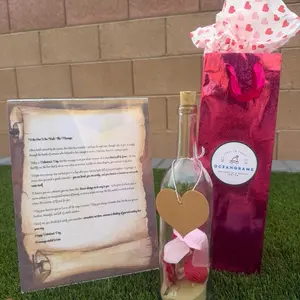 Oceangrams Perfect Valentine’s Day Gift - Glass Message in a Bottle on Scroll Paper with Red & Pink Petals, Tan Sand and Seashells.
