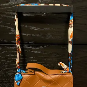Temu baby brown purse came with a silk strap u tie on to The purse super cute