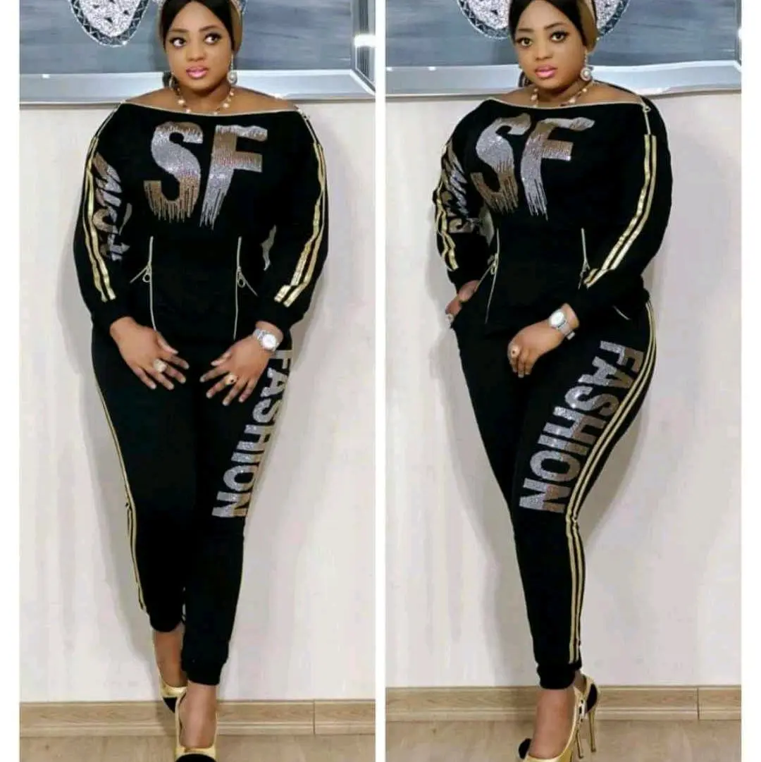 Two piece zip up shoulder top and pants dress track for ladies.