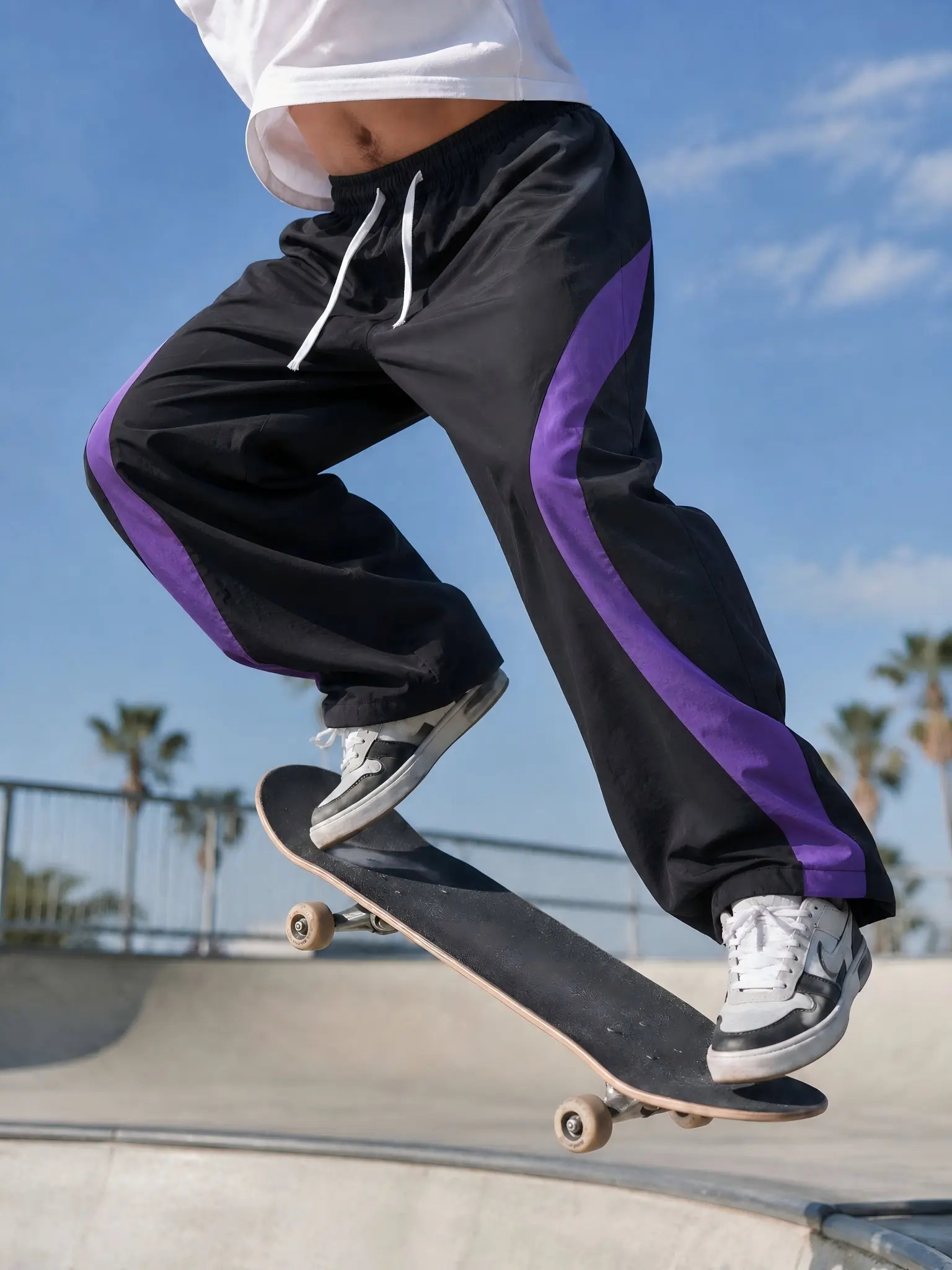 Single piece American color-block curved patchwork quick-dry wide-leg casual pants for men and women; black-and-purple patchwork, drapey straight-leg street sports long pants; sold individually.