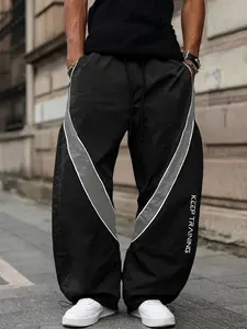 Trendy men's sports pants with letter print, colorblock design, drawstring waistband, suitable for exercise, casual wear, and daily commuting. Can be worn with jackets and sweatshirts, making it a perfect choice for all seasons.