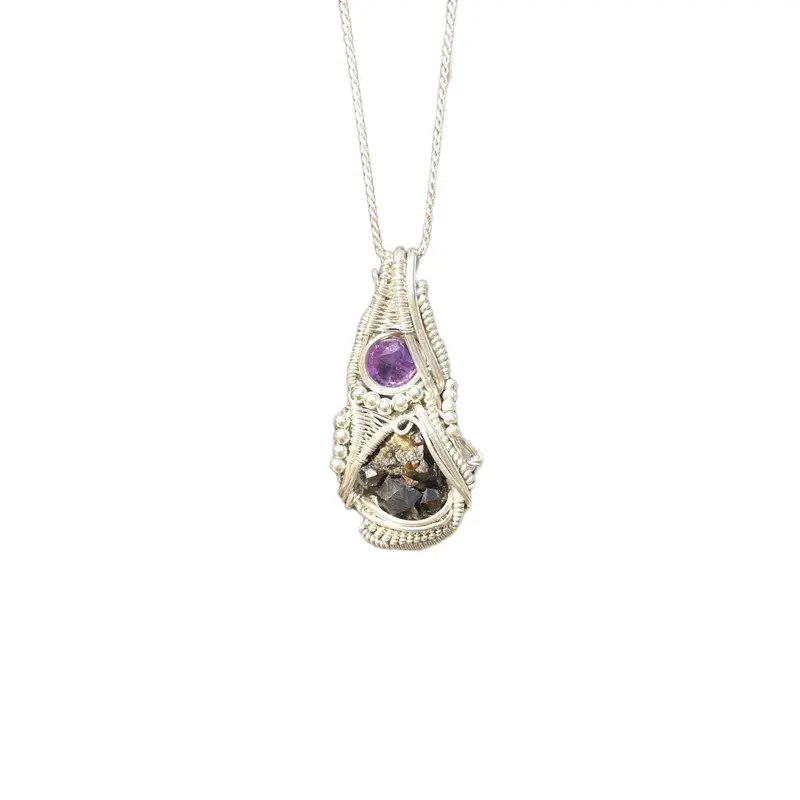 Raw andradite garnet cluster and amethyst facet wire wrapped by Frances coyne for Coynes Crystals comes with sterling silver rope chain.