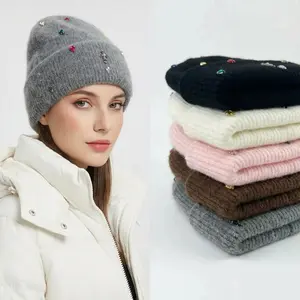 Fashionable colored rhinestone artificial 100% plush knitted hat, warm and soft for winter outdoor use, with earmuffs.
