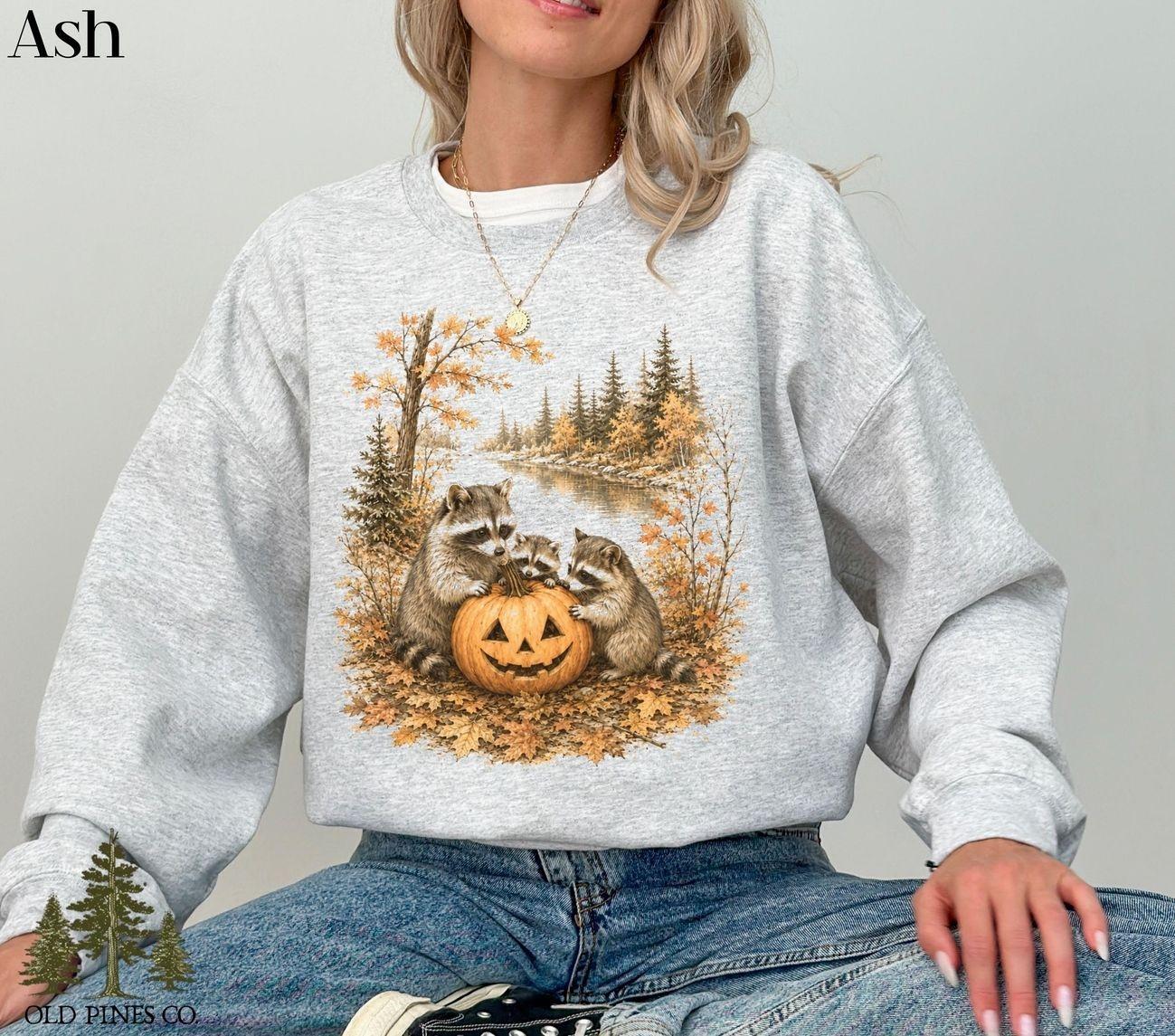 Cute Raccoons Pumpkin Sweatshirt, Vintage Fall Forest Shirt, Cute Halloween Raccoon T-Shirt, Autumn Lake Wildlife Gift, Spooky Season Cottagecore Apparel, Animal Lover Thanksgiving Crewneck, Cozy Autumn Leaves Outfit, Fall Gift for Women & Men