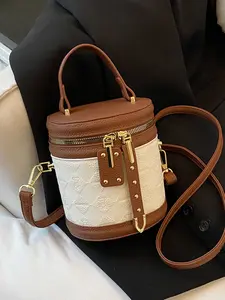The embossed, cylindrical, Pu leather bag, used as handbag or crossbody bag, has large capacity, holds mobile phone, versatile for commuting, suitable for college students, office workers, shopping, dating