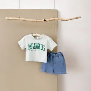Two-piece summer baby outfit: light green short-sleeve top with letter print + loose denim shorts for infants and toddlers