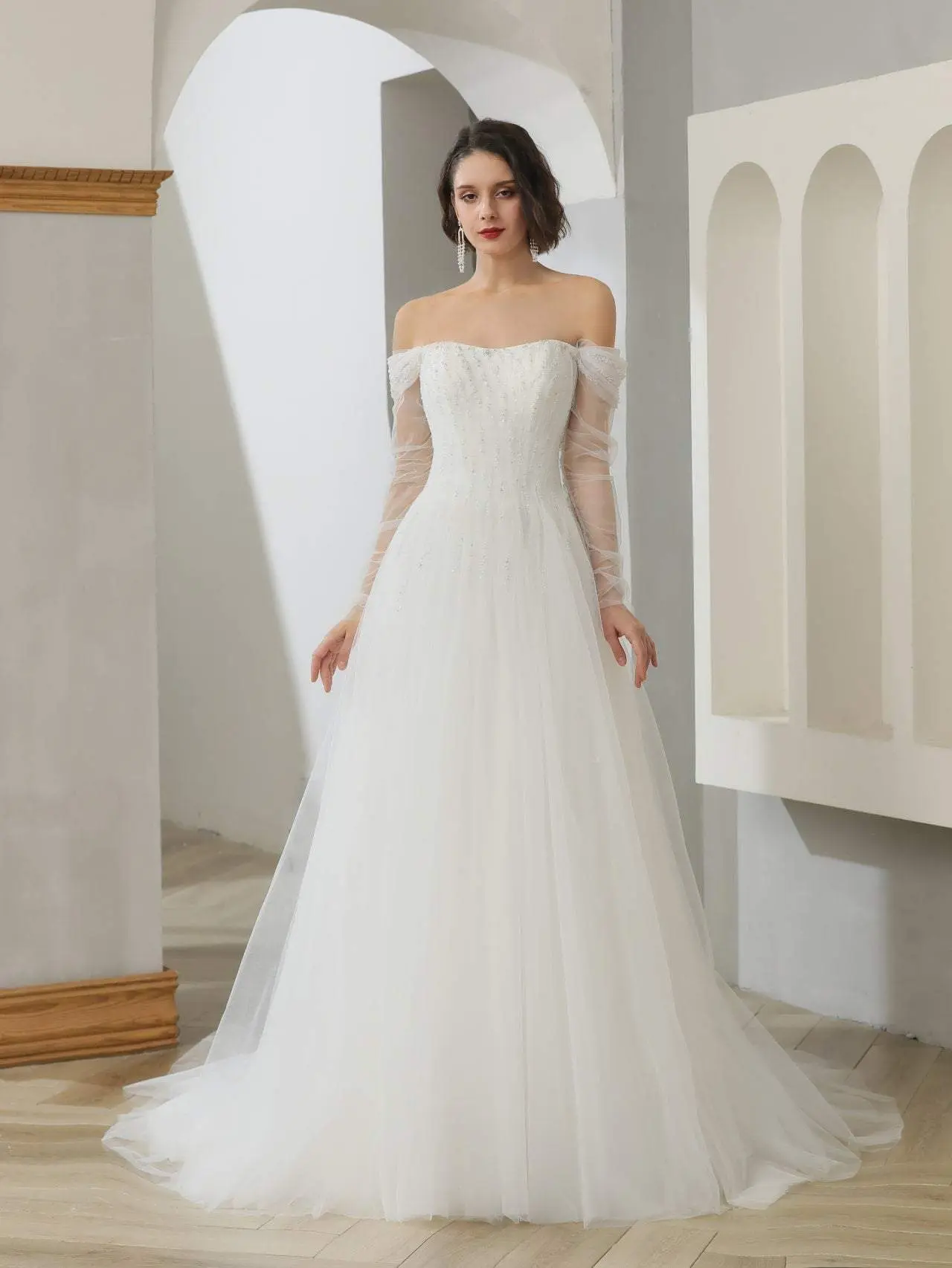 Off-Shoulder A-Line Wedding Gown in Light Ivory with a Beaded Lace Bodice, Satin Skirt, Sheer Sleeves, and Chapel Train